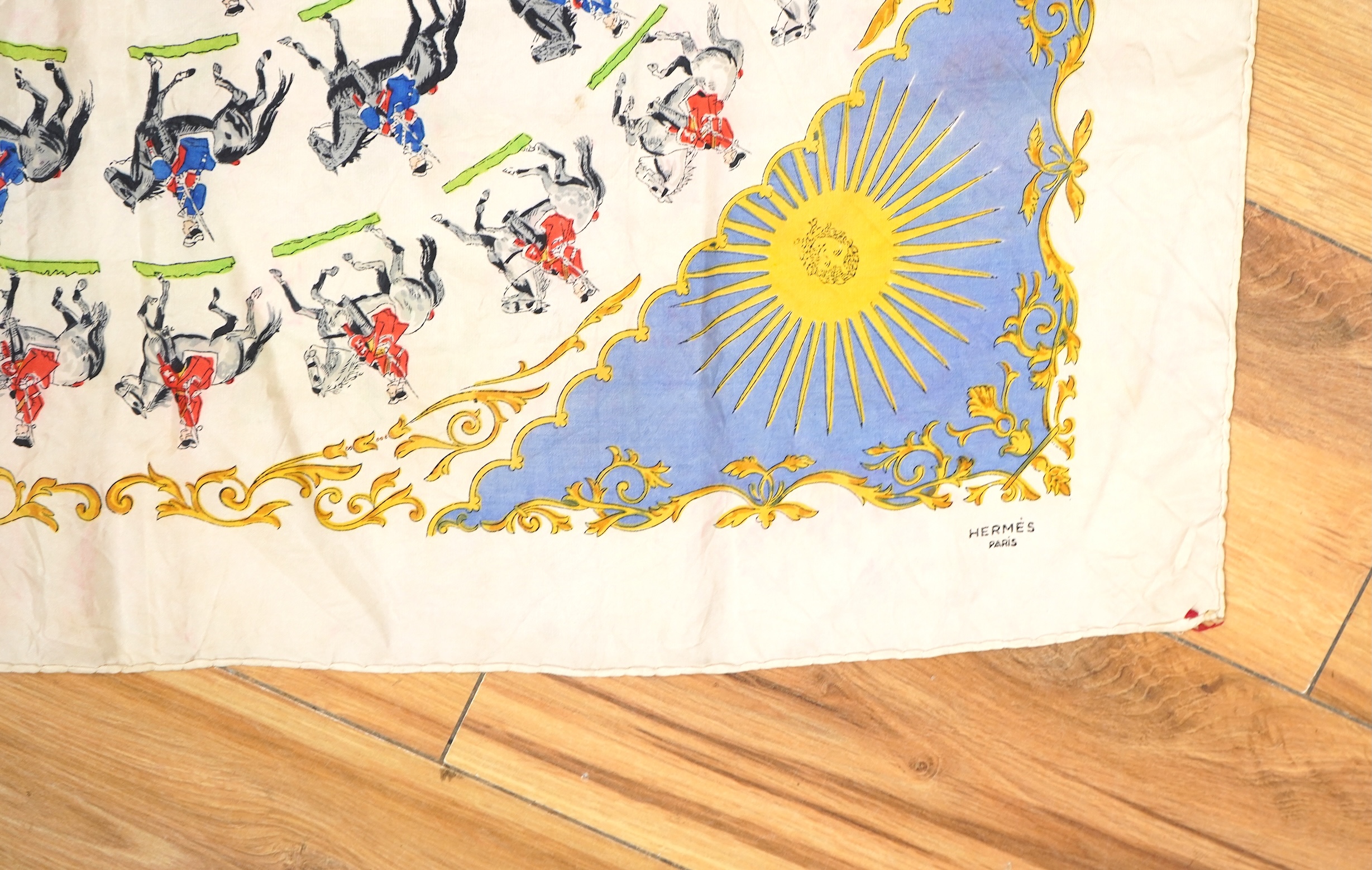 A collection of three Hermes silk scarves and a Chanel monogram example